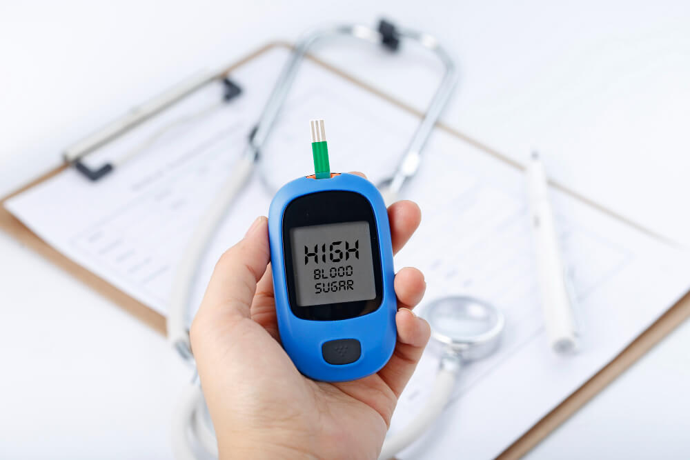 hand-holding-blood-glucose-meter-measuring-blood-sugar-background-is-stethoscope-chart-file-1-1.jpg