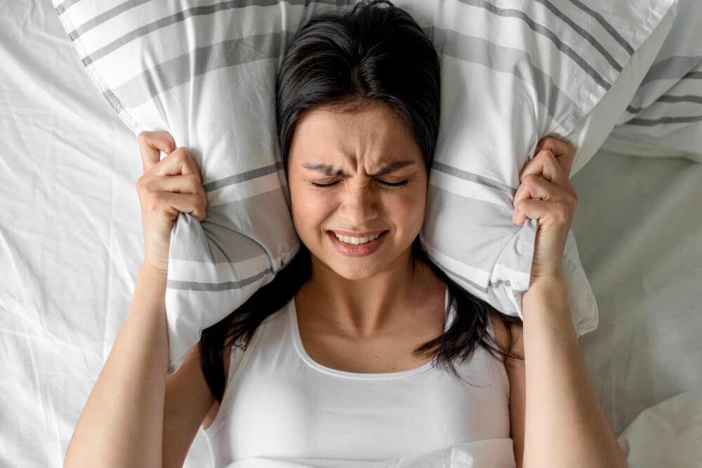 top-view-young-woman-holding-pillow-bed-1.jpg